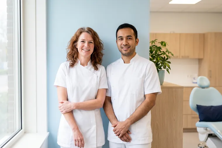 Two team members in white work clothes in the treatment room